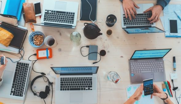 People working at laptops on a desk