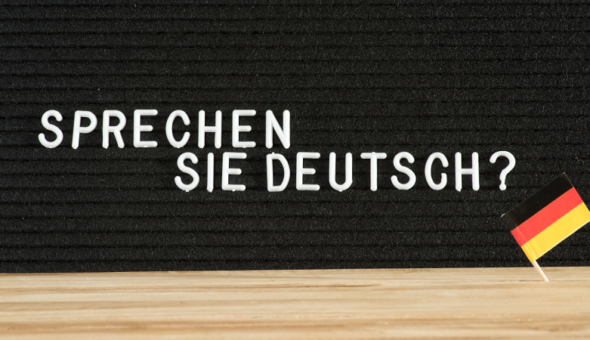 Notice board displaying the words 'Sprechen Sie Deutsch?' and a little German flag.