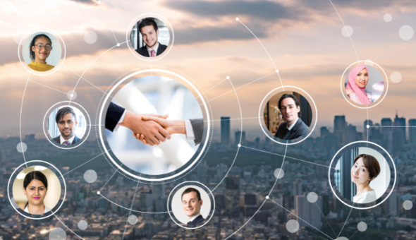 Headshots of people from different backgrounds using intercultural skills to connect with each other and work together effectively in a global network. In the background is a big city with lots of skyscrapers. There's a handshake in the centre of the image representing commercial success.