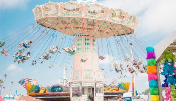 a picture of a fair ride with lots of chairs flying around a rotating middle.