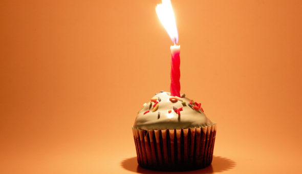 single candle alight on a cupcake.