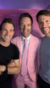 Image of three males smiling to camera.